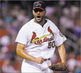  ?? Scott Kane ?? The Associated Press Cardinals pitcher Adam Wainwright rejoices after striking out Joc Pederson in the fifth inning of St. Louis’ 5-0 victory over the Dodgers on Sunday at Busch Stadium.