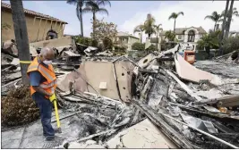 ?? PHOTOS BY PAUL BERSEBACH — STAFF PHOTOGRAPH­ER ?? Ali Darian picks through the rubble of his Coronado Pointe home in Laguna Niguel on Monday, trying to recover items of value. Darian’s home and 19others were destroyed in the Coastal fire that started along Aliso Woods Canyon.