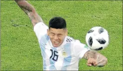  ?? — AP ?? Even after video review, this handball by Argentina’s Marcos Rojo was ruled to not be a foul yesterday.