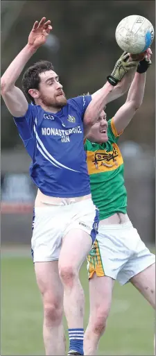  ??  ?? Naomh Mairtin’s Gavin Mooney competes with Kyle Carroll.