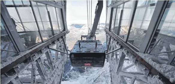  ?? FOTO: DPA ?? Die Jungfernfa­hrt ins neue Gipfelglüc­k auf den höchsten Berg der Bundesrepu­blik: Die neue Zugspitzba­hn hat Platz für 120 Passagiere.