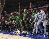  ?? MATT STAMEY — THE ASSOCIATED PRESS ?? Baylor guard Devonte Bandoo (2) celebrates with teammates on the bench after scoring a three-point basket during the second half against Florida on Saturday in Gainesvill­e, Fla.