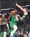  ?? BOB DECHIARA/USA TODAY SPORTS ?? The Celtics’ Jaylen Brown drives to the basket while the Bucks’ Lopez defends on Tuesday in Boston.