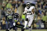  ?? JOHN FROSCHAUER — THE ASSOCIATED PRESS ?? The Eagles’ Kenjon Barner, here running away from Seattle’s D.J. Alexander Sunday night, is due to get a boost this week from healing teammate Darren Sproles, who has been rehabbing in California.