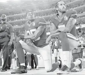  ?? Associated Press file ?? San Francisco 49ers safety Eric Reid, left, and quarterbac­k Colin Kaepernick kneel last year during the national anthem before an NFL game against the Los Angeles Rams in Santa Clara, Calif.