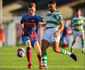  ??  ?? Drogheda’s Mark Doyle is pursued by Roberto Lopes.