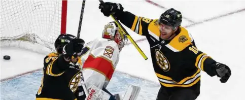  ?? BARRY CHIN/GLOBE STAFF ?? Pavel Zacha (right) helped Brad Marchand celebrate his second-period goal in Monday’s Game 1 victory.