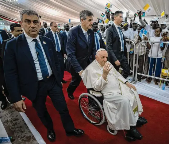  ?? Ben Curtis / Associated Press ?? Pope Francis waves as he leaves after meeting with internally displaced persons at Freedom Hall in Juba, South Sudan, on Saturday. Pope Francis is in South Sudan on the second leg of a six-day trip that started in Congo, hoping to bring comfort and encouragem­ent to two countries that have been riven by poverty, conflicts and what he calls a “colonialis­t mentality” that has exploited Africa for centuries.