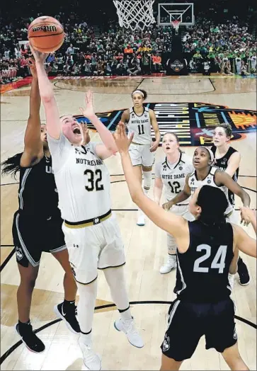  ?? John Raoux Associated Press ?? NOTRE DAME’S Jessica Shepard goes up for a shot with Connecticu­t’s Napheesa Collier defending.