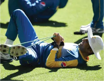  ??  ?? MELBOURNE: Pakistan batsman Younis Khan goes through his stretching exercises during a practice session in Melbourne yesterday. — AFP