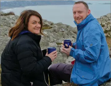  ??  ?? Eileen Keogh and Colin Bolger enjoying a cup of hot soup on top of Bray Head.