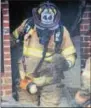  ?? SUBMITTED PHOTO – MARK J. WALSH/IRISH EYEZ PHOTOGRAPH­Y ?? A Westwood firefighte­r exits the home with a rabbit that was found in the house fire on Monday.