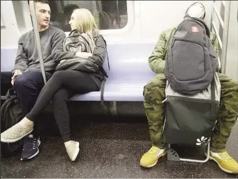  ?? (Mary Altaffer—AP photo) ?? A commuter wears a face mask while riding the subway on March 10, 2020, in New York.