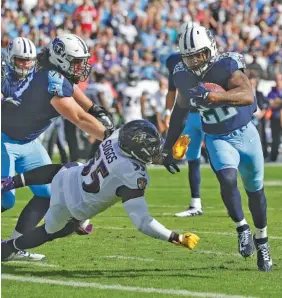  ?? THE ASSOCIATED PRESS ?? Tennessee Titans running back Derrick Henry gets past Baltimore Ravens outside linebacker Terrell Suggs to score a touchdown on a 1-yard run in the first half.