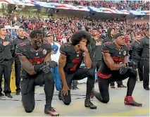  ?? PHOTO: USA TODAY ?? Eric Reid, right, kneels alongside Eli Harold and Colin Kaepernick during the US national anthem last year.