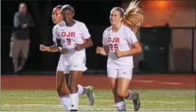  ?? AUSTIN HERTZOG — DIGITAL FIRST MEDIA ?? Owen J. Roberts’ Mahogany Willis (9) and Mia Baumgartne­r (25) smile after connecting for Willis’ second-half goal during a game against Boyertown.