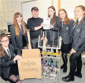  ??  ?? Top team Josh Valman with, from left, Emma McGhie, Hannah Price, Madeleine Dick, Kayleigh Tart, Ellie Suttie and their winning robot