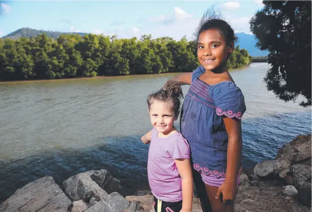  ?? Picture: STEWART McLEAN ?? CALL ON RANGERS: Machans Beach girls Kirra Plithakis, 5, and Denicka Barnes, 7, point out where they saw the croc on the river’s opposite bank.