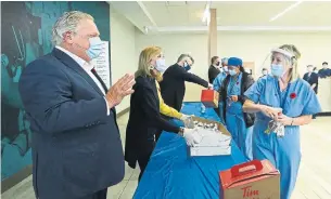  ?? NATHAN DENETTE THE CANADIAN PRESS ?? Premier Doug Ford delivers treats to Humber River Hospital on Thursday. The decision to prioritize opening businesses during the second wave of the pandemic belongs to Ford, whose public statements indicate he does not understand it, and his government, Bruce Arthur writes.