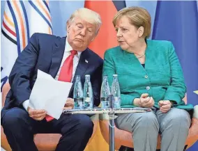  ?? POOL, GETTY IMAGES ?? President Trump and German Chancellor Angela Merkel attend a G20 summit in Hamburg.