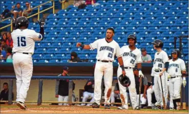  ?? MICHAEL P. PAYNE — THE NEWS-HERALD ?? Jose Vicente is greeted at home plate by Jonathan Laureano (23) and Jose Medina (25) after hitting a home run against Dayton on June 7 at Classic Park.