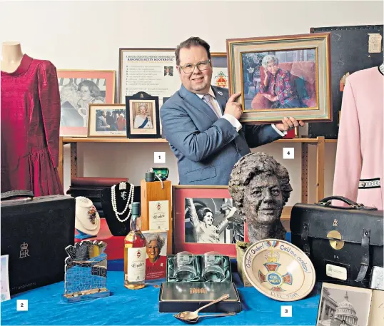  ?? ?? SAS Auctioneer, Thomas Forrester, with Lady Boothroyd’s collection of prized mementos