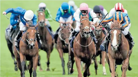  ?? Picture: ALAN CROWHURST/ GETTY IMAGES ?? LEAP FORWARD: Ryan Moore, riding Love (right, blue/orange) wins the Qipco 1000 Guineas Stakes at Newmarket Racecourse on Sunday in Newmarket