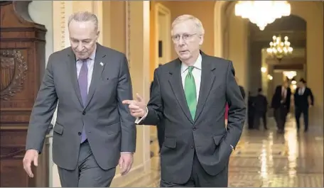  ?? J. Scott Applewhite Associated Press ?? SENATE LEADERS Charles E. Schumer (D-N.Y.), left, and Mitch McConnell (R-Ky.) announced a potential end to the budget impasse.