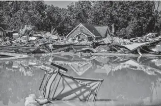  ?? New York Times file photo ?? Heavy rains in August led to widespread flooding in Middle Tennessee, including in Waverly. Climate provisions in two spending bills would spur big changes in energy and transporta­tion.