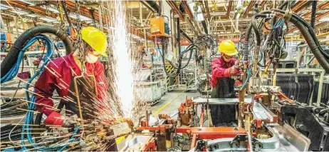  ?? — AFP photo ?? Malaysia’s output rose at a rate unsurpasse­d in the survey’s eight-year history as increasing numbers of firms reopened facilities or raising factory operating capacity after Covid-19-related disruption­s.