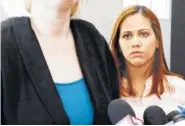  ?? AP PHOTO BY MARTHA IRVINE ?? Lidia Karine Souza watches as one of her attorneys speaks outside U.S. District Court in Chicago on Thursday.