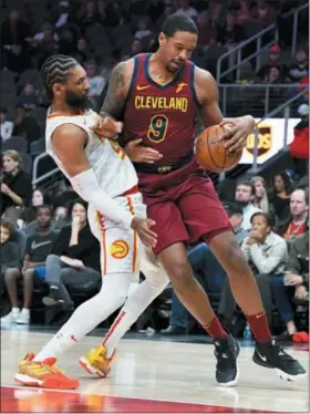  ?? JOHN AMIS — ASSOCIATED PRESS ?? Channing Frye drives against the Hawks’ DeAndre’ Bembry on Dec. 29 in Atlanta.