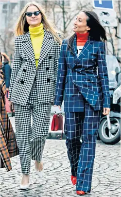  ??  ?? Check it out: Holly Russell and Elizabeth von der Goltz, buyers at Net-a-porter, are among the lovers of the checked trouser suit. Holly wears a Petar Petrov gingham wool suit (blazer £950, trousers, £575) and Elizabeth wears Gabriela Hearst checked wool suit (blazer, £1,650, trousers, £950, all net-a-porter. com)
