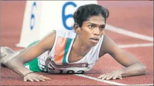  ?? AFP PHOTO ?? Santhi Soundaraja­n lies on the track after edging out Kazakhstan’s Viktoriya Yalovtseva for second place in the women’s 800m final during the 15th Asian Games in Doha on December 9, 2016