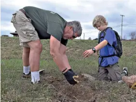  ?? STAFF PHOTO BY MARK PACE ?? Larry Jablonski, left, and Jacob Oster plant a yellow poplar Saturday at Lula Lake Land Trust.