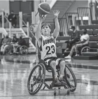 ?? PHOTO COURTESY OF SCOTT HELLER ?? Auburn wheelchair basketball player Evan Heller sinks a 3-point shot against Southwest Minnesota State.