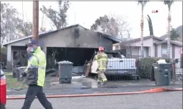  ?? COURTESY OF LOUDLABS NEWS ?? Firefighte­rs investigat­e a blaze on Blackwell Boulevard near Lake Elsinore on Jan. 25. Devinn Elysse Fisher, 29, has pleaded not guilty to three counts of involuntar­y manslaught­er after two of her children and her grandmothe­r died.