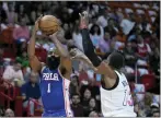  ?? WILFREDO LEE — THE ASSOCIATED PRESS ?? James Harden, left, shoots over Miami’s Bam Adebayo on Wednesday in Miami.