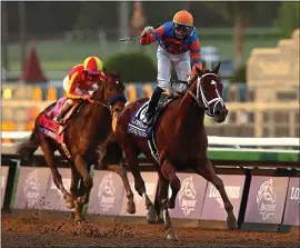  ?? JOE SCARNICI — GETTY IMAGES ?? Airad Ortiz Jr., riding Vino Rosso, celebrates Saturday after crossing the finish line ahead of Joel Rosario and Mckinzie in the Breeders’ Cup Classic at Santa Anita Park.