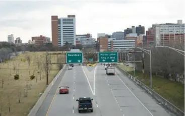  ?? BARBARA HADDOCK TAYLOR/BALTIMORE SUN ?? Vehicles move along the “Highway to Nowhere” on Tuesday in West Baltimore.