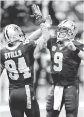  ?? JOHN DAVID MERCER, USA TODAY SPORTS ?? The Saints’ Kenny Stills high- fives Drew Brees after catching a 52- yard touchdown pass Sunday.