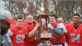  ?? SAM STEWART - DIGITAL FIRST MEDIA ?? Owen J. Roberts celebrates with the Thanksgivi­ng Day trophy after defeating Pottstown 23-6 Thursday afternoon.