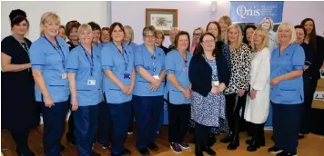  ?? ?? Jacqueline Meek, second from the right on the front row, with colleagues at the Queen’s Nursing Institute Scotland award for long service celebratio­n event. Image: NHS Lanarkshir­e