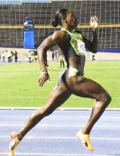  ?? (Photo: Garfield Robinson) ?? Rushell Clayton powers to victory in heat one of the women’s 400m at the JW Speedfest at the National Stadium on Saturday.