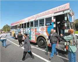  ?? JANE TYSKA/STAFF ?? The psychedeli­c bus awaits passengers returning from a tour stop.