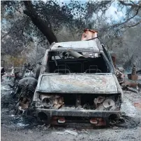  ?? AFP ?? The remains of fire damaged vehicles are lying outside a home in the hills of Toro Canyon, north of Santa Barbara, California, as firefighte­rs continue to battle the Thomas Fire in Ventura and Santa Barbara Counties where over 230,000 acres have...