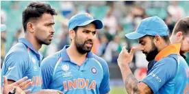  ?? — AP ?? Virat Kohli gestures during the award ceremony of the Champions Trophy as teammates Hardik Pandya (left) and Rohit Sharma look on at The Oval in London on Sunday.