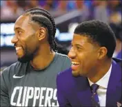  ?? Ezra Shaw Getty Images ?? KAWHI LEONARD, left, and Paul George have yet to team up on the court for the Clippers.