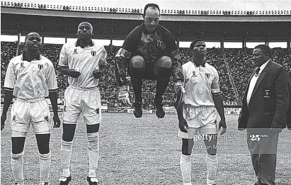  ??  ?? ULTIMATE WARRIOR . . . Zimbabwe skipper Francis “Captain Sandura’’ Shonhayi (third from right) and his Warriors (from left) the late Benjamin Nkonjera, Peter Ndlovu, Bruce Grobbelaar and team manager, the late Jimmy ‘’Daddy’’ Finch wait for the pre-match activities to end before plunging into an internatio­nal match at the National Sports Stadium during the Dream Team era