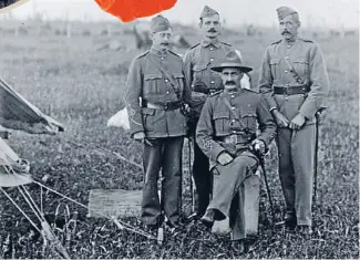  ?? Photo: George Leslie Adkin, from Alexander Turnbull Library reference 1/2-065624-G ?? Lieutenant Colonel and commanding officer William Malone, seated, and three officers from the Taranaki Volunteers in about 1911.